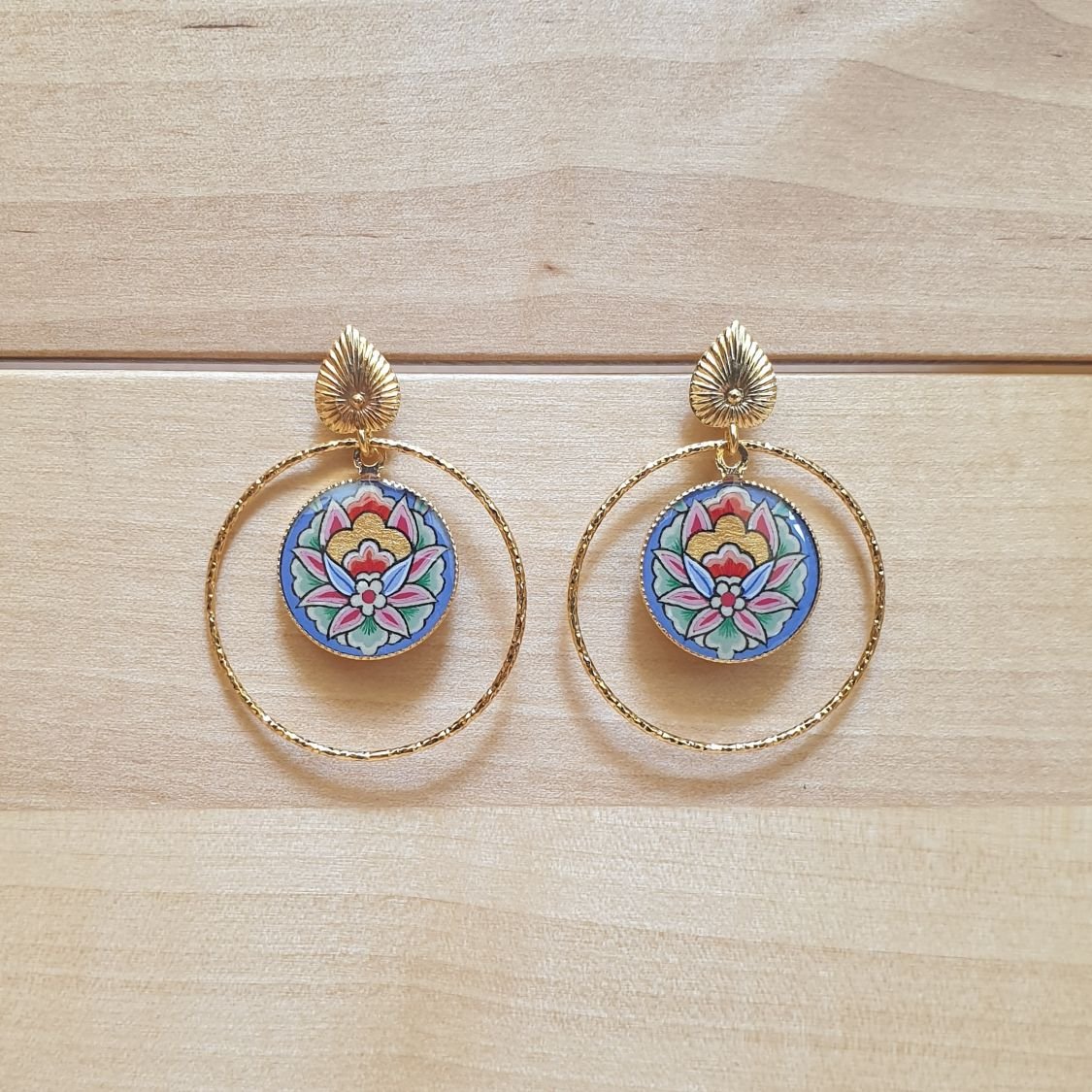 Brincos pendentes de flores orientais com fundo azul