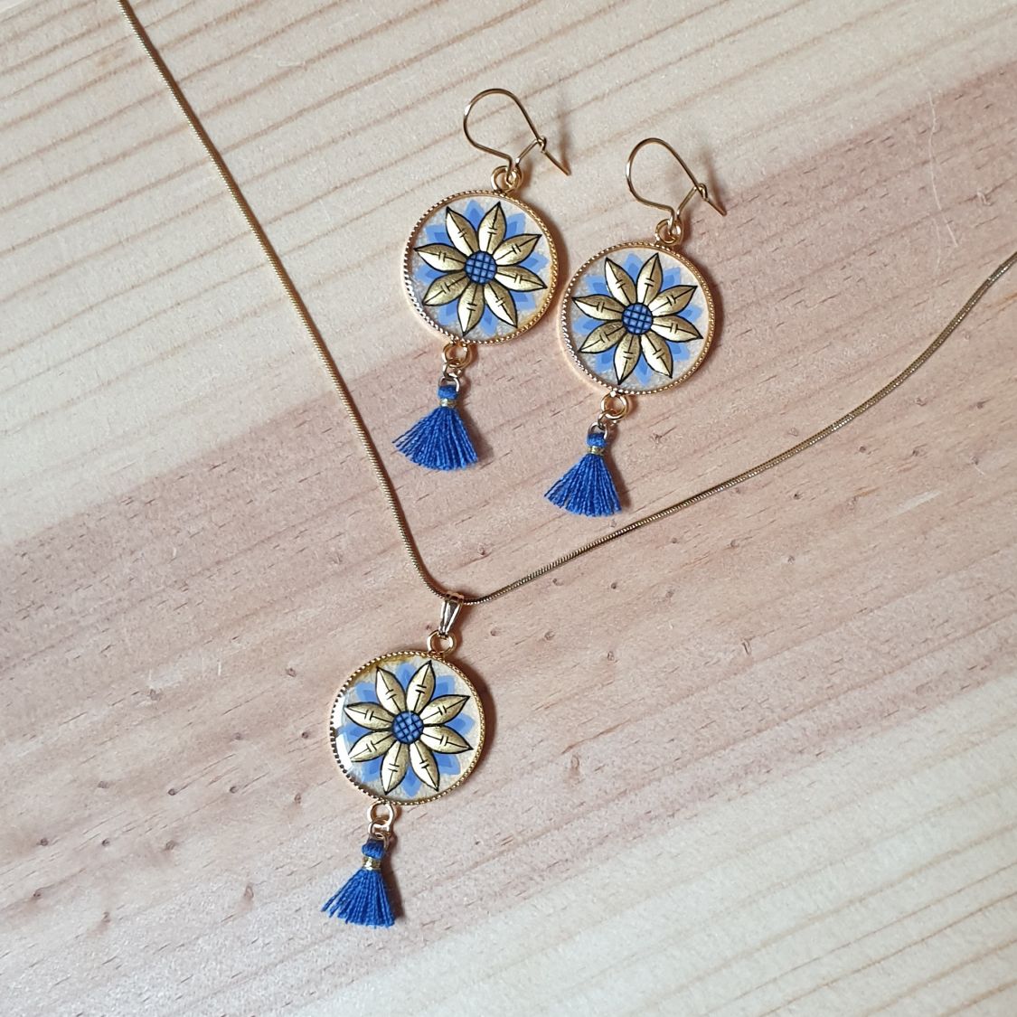 Colar pendente ouro/azul de flores sobre corrente de ouro