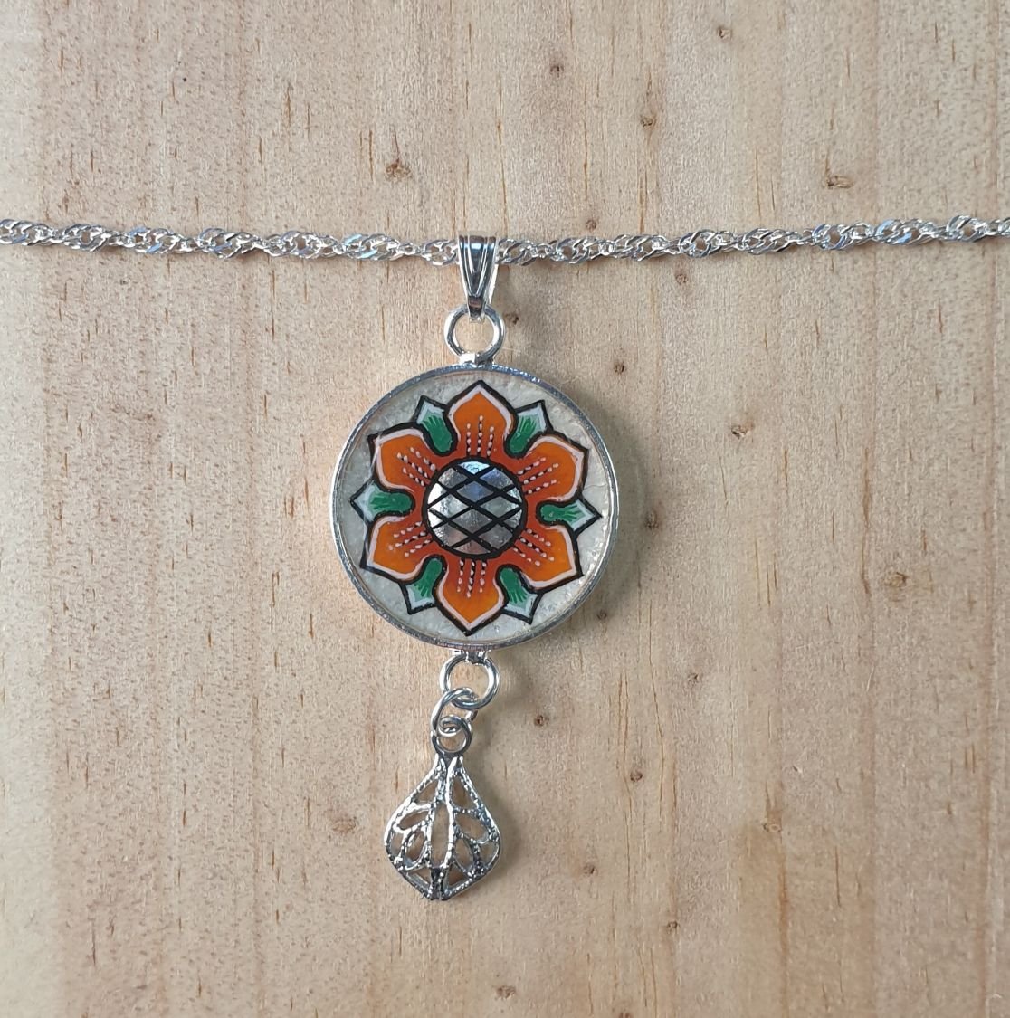 Colar com pingente de flores laranja/ouro sobre corrente de prata