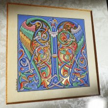 Letra românica iluminada M emoldurada